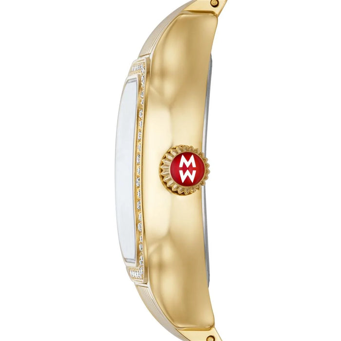 A close-up side view of a gold-tone watch with a white dial and a red circular crown accent featuring a white 'MW' logo.
