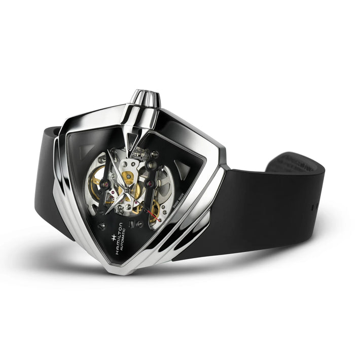 Hamilton wrist watch with a shield-shaped silver-tone case, skeleton dial showing the mechanical movement, and a black strap on a white background.
