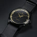 Hamilton watch with black strap and black dial on a dark background