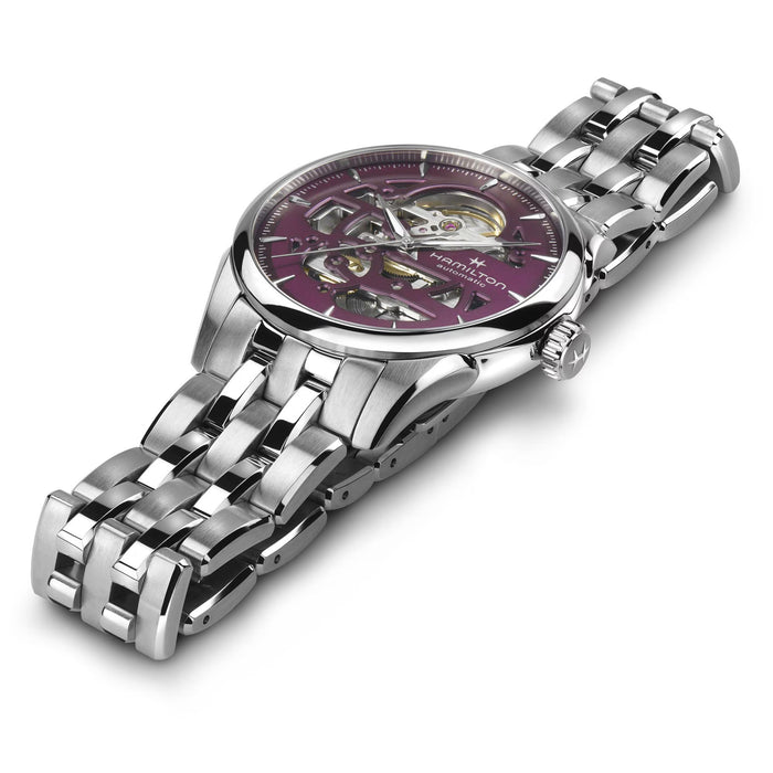 Silver watch with a pink face on a white background