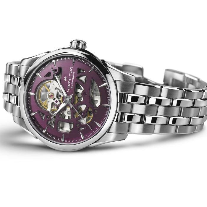 Silver watch with a purple face on a white background