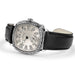 A luxury watch by Richard Mille, featuring a silver-toned bezel with intricate cutouts, a silver dial with black Arabic numerals, and a black leather strap, shown on a white background.