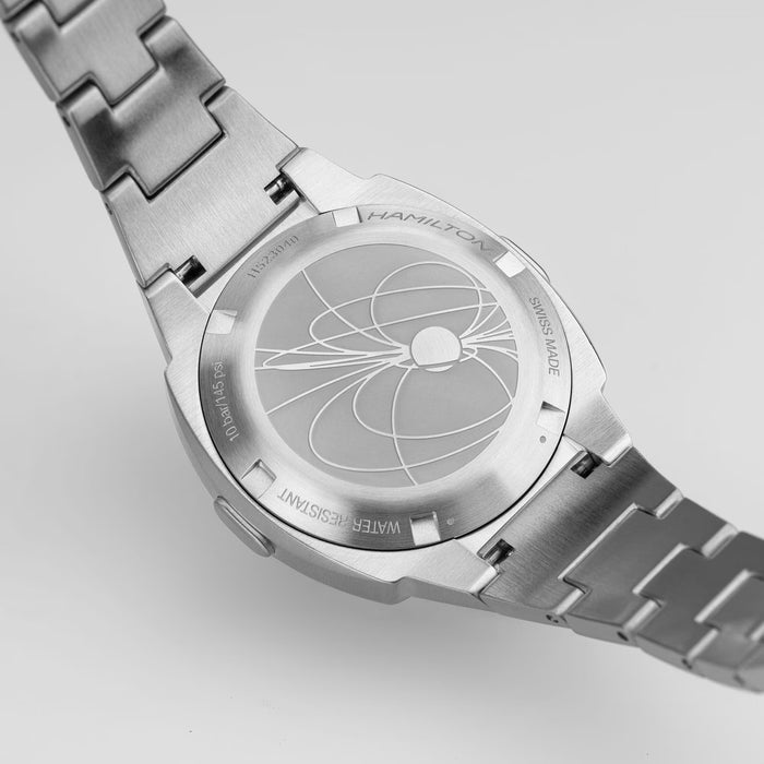 Silver Hamilton watch with detailed engraving on a light gray background