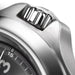 Close-up of a silver watch with a detailed texture on the case.