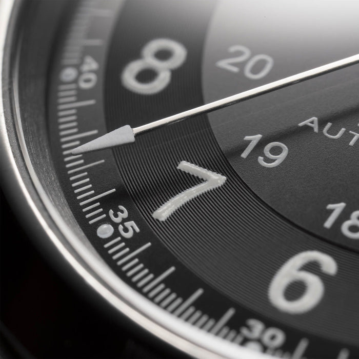 Close-up of a watch dial with numbers and hands