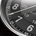 Close-up of a watch dial with numbers and hands