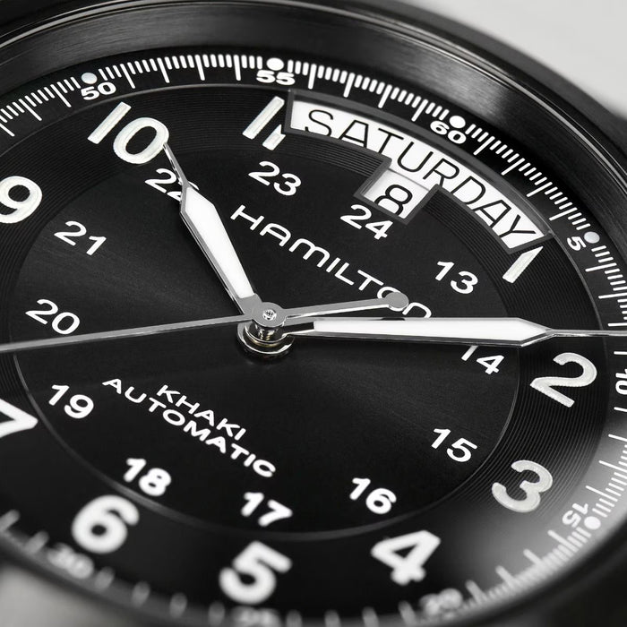 Close-up of a Hamilton watch face with black dial and silver accents.