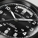 Close-up of a Hamilton watch face with black dial and silver accents.