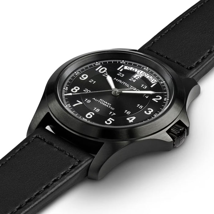 Black wristwatch with a detailed face on a white background