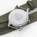 Watch case with engraving on a green strap