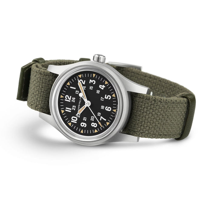 Watch with green strap and black dial on a white background