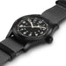 Black wristwatch with gray strap on a white background