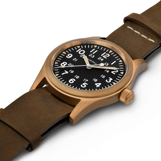 Watch with brown strap and bronze case on a white background