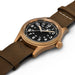 Watch with brown strap and bronze case on a white background