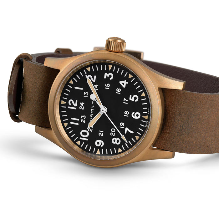 Watch with brown leather strap and bronze case on white background