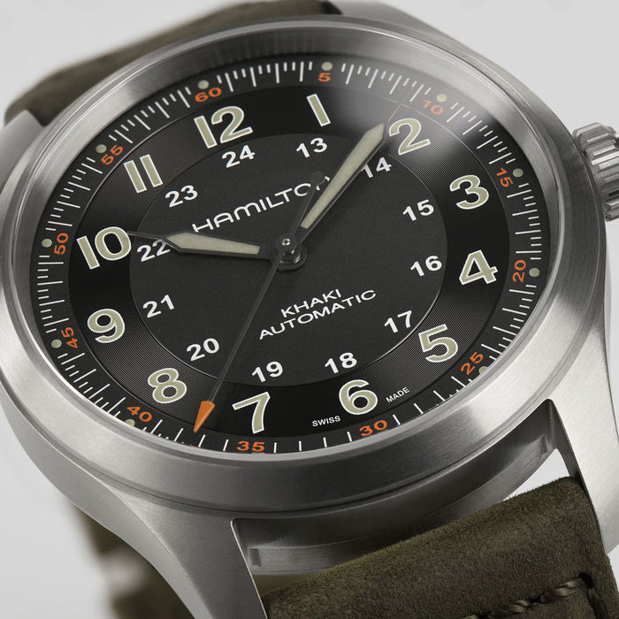 Hamilton watch with black dial and brown leather strap on a white background