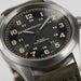 Hamilton watch with black dial and brown leather strap on a white background