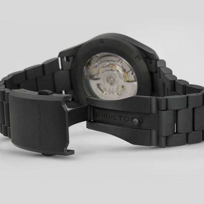 Black Hamilton watch with open face on a light gray background