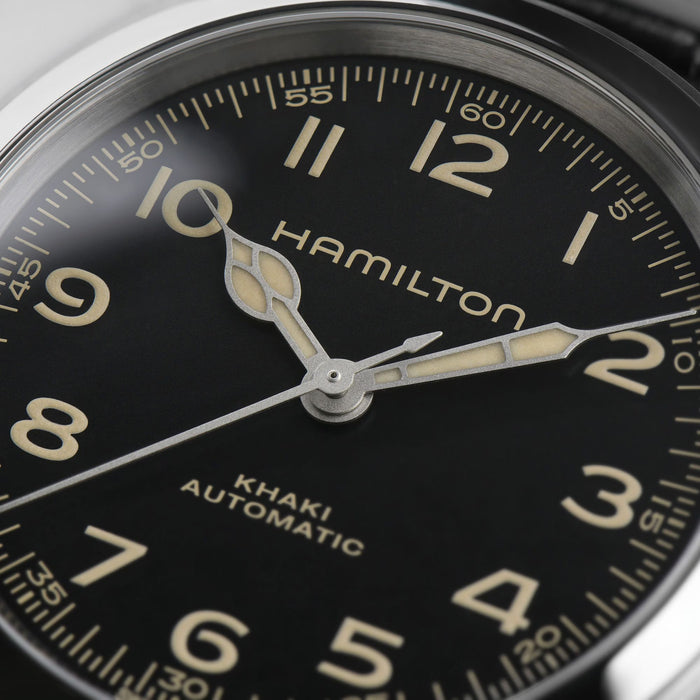 Hamilton watch face with black dial and gold accents