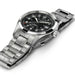 Silver wristwatch with black dial on a white background