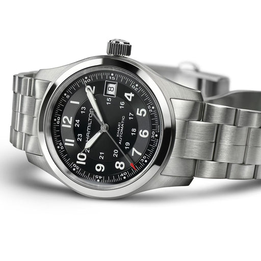 Silver wristwatch with black dial on a white background