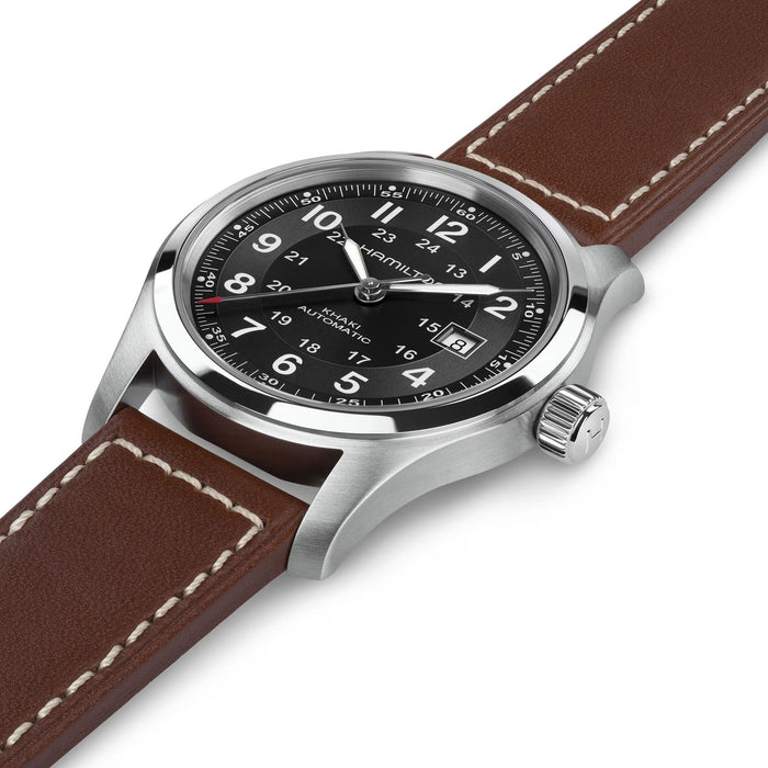 Hamilton watch with brown leather strap and black dial on a white background