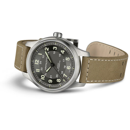 Watch with brown leather strap and black dial on a white background