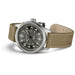 Watch with brown leather strap and black dial on a white background