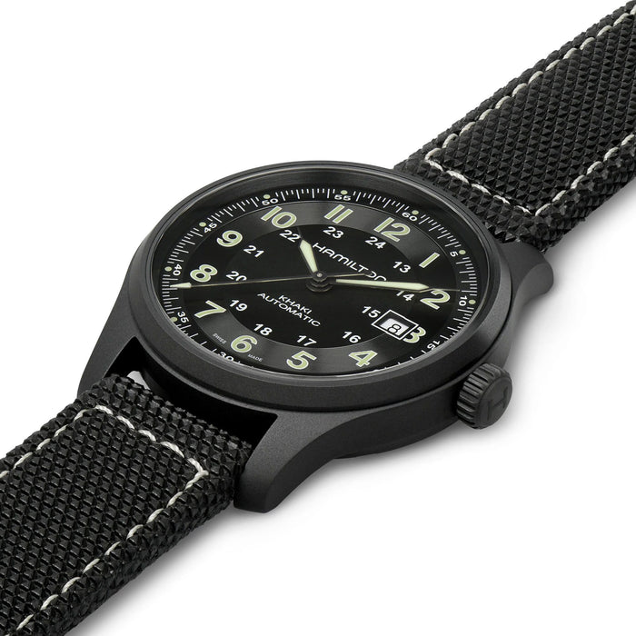 Black wristwatch with detailed face on a white background