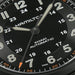 Close-up of a Hamilton watch face with black dial and white markings.