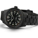 Black wristwatch with detailed face on a white background