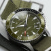 Hamilton watch with green dial and strap on a white background