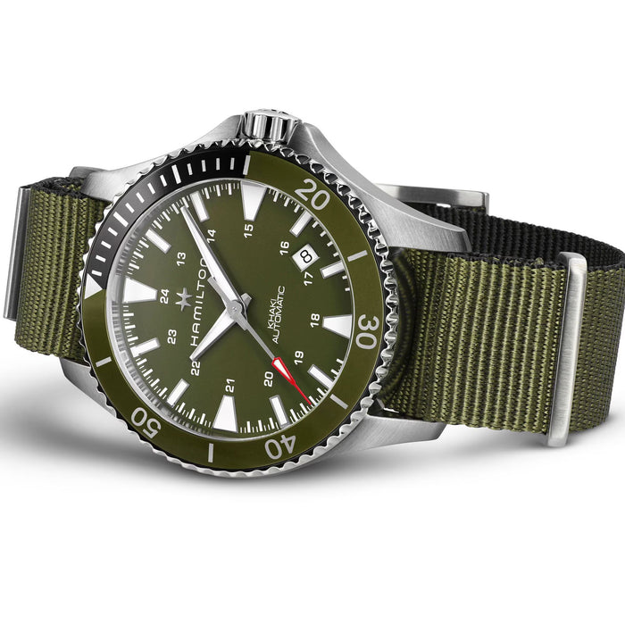 Green watch with silver bezel and olive green strap on a white background