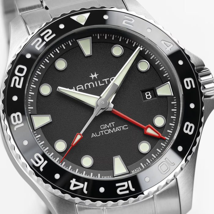 Hamilton watch with black dial and silver case on a white background