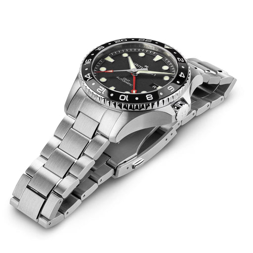 Silver watch with black dial on a white background