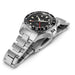Silver watch with black dial on a white background